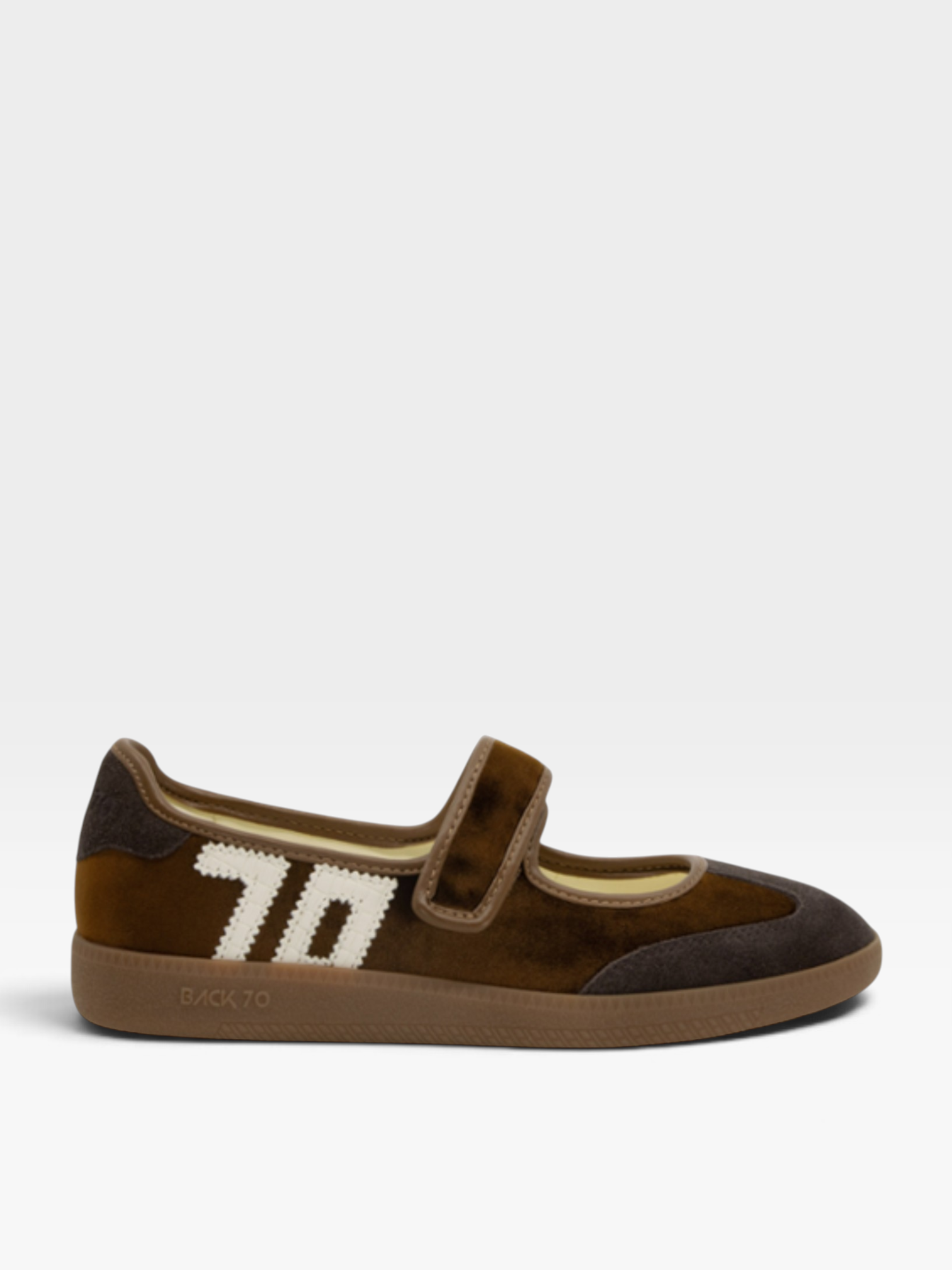 A single brown suede and leather shoe with a hook-and-loop strap and a large white '70' graphic on the side, shown against a light gray background.