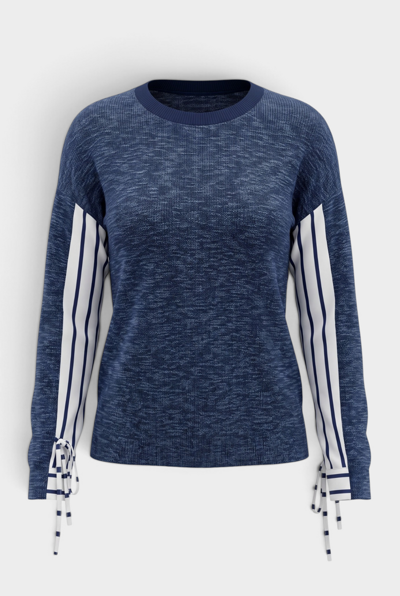 The Stitch Drop Grayton Beach Sweater which is a navy blue heathered knit sweater with white and navy striped sleeve panels and matching striped tie-front cuffs, shown on a light gray background.