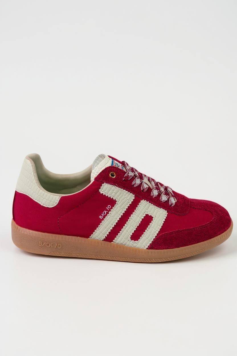 Red sneaker with white accents on a light gray background