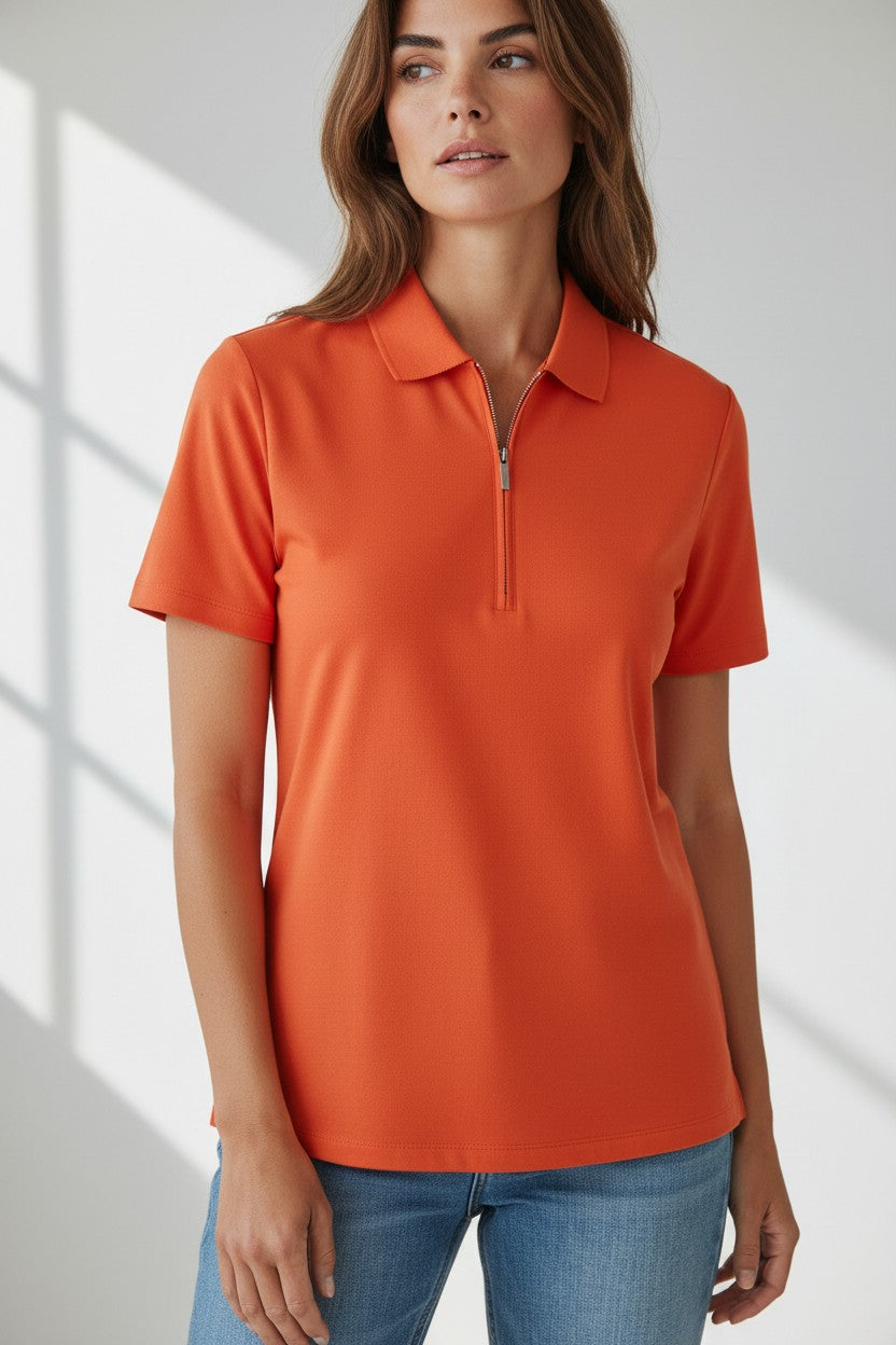 Woman wearing the Renuar Knit Zip Top in Orange Jilli Boutique